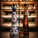 Luxury Tequilas Texans Love: Clase Azul, Don Julio 1942, and More Clase Azul Reposado and Don Julio 1942 luxury tequila bottles with glass of tequila on bar