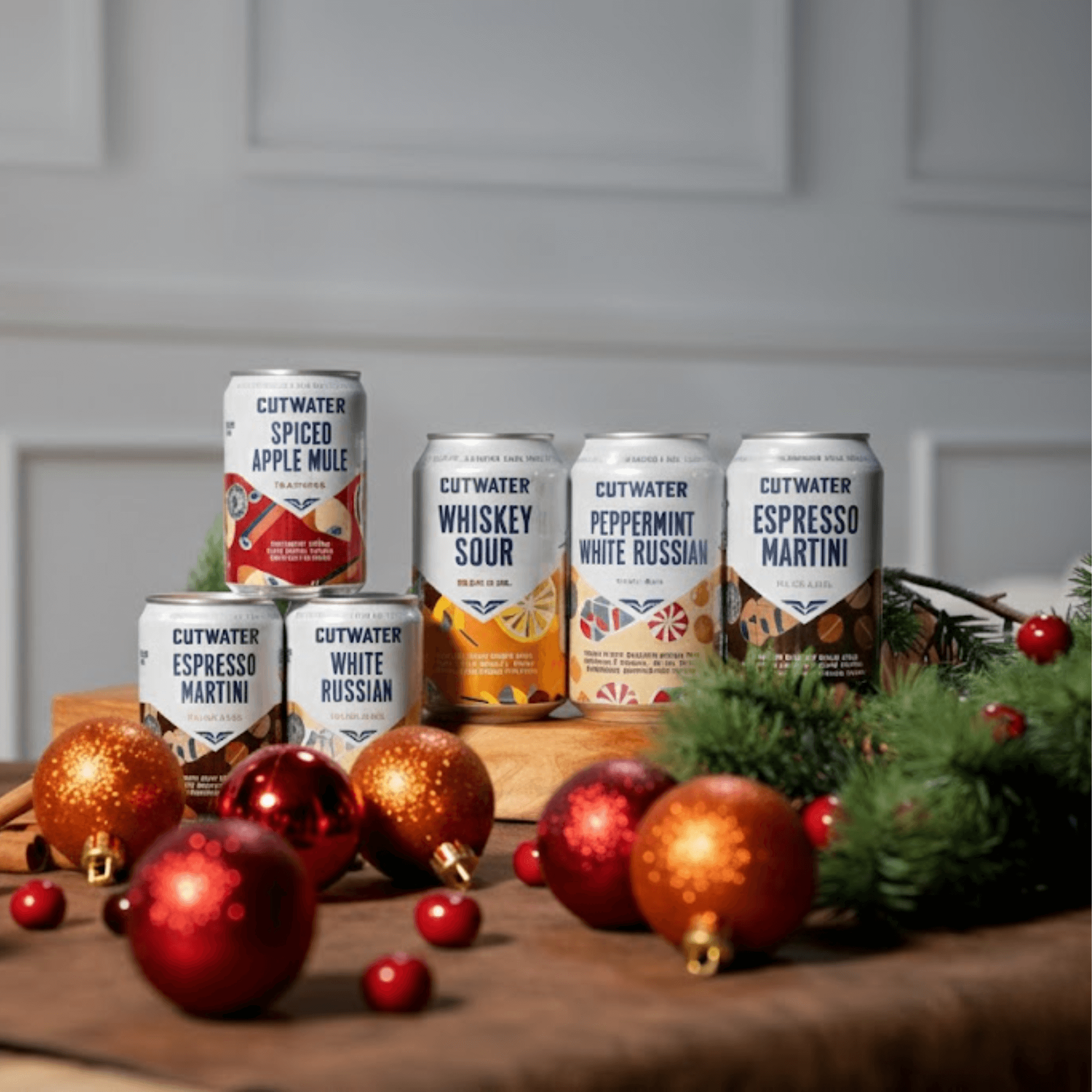 Holiday Cutwater cocktails surrounded by ornaments and greenery