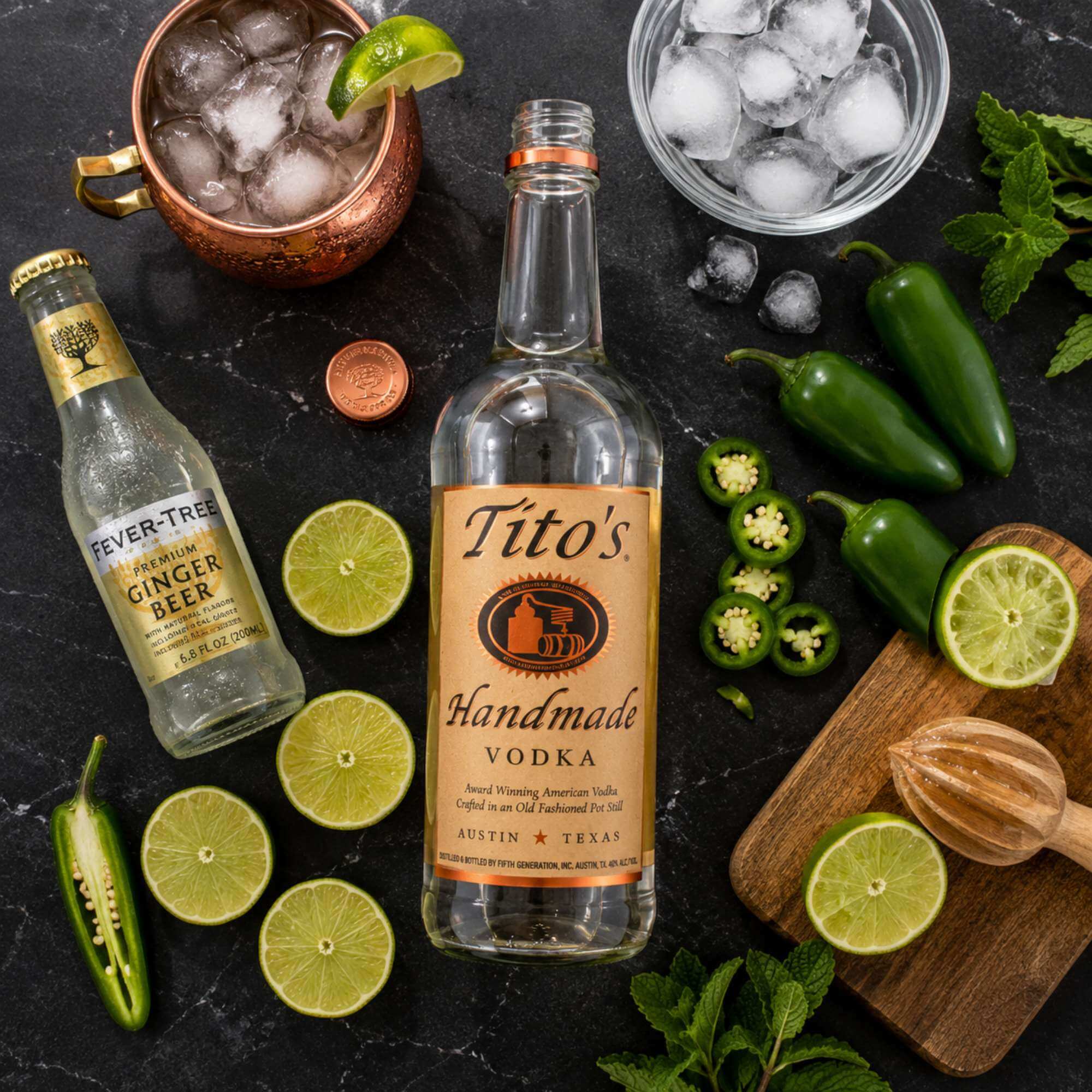 texas-vodka-cocktails-preparation-2026 Texas Mule cocktail ingredients with Tito's vodka, fresh jalapeños, limes, and ginger