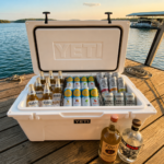 Texas lake house drinks 2026 featuring High Noon hard seltzers, Modelo Especial beer, Tito's vodka, and Espolón tequila stocked in a cooler at a Texas lake