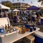 A tailgate setup with coolers and folding chairs before an SFA football game
