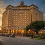 The Haunted History of Mineral Wells' Baker Hotel The historic Baker Hotel tower rising over downtown Mineral Wells, Texas at dusk